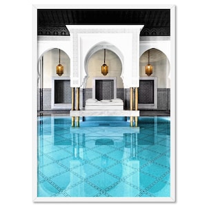 May include: A white structure with three arches over a blue tiled pool. The structure has gold columns and hanging lanterns. The pool is reflecting the structure and the sky.