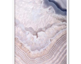 May include: A framed print featuring a close-up of an agate stone. The artwork showcases layers of white, beige, and gray hues, with intricate patterns and textures. The natural stone design is set within a white frame.