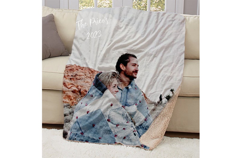 May include: A personalized fleece blanket with a photo of a couple in a desert landscape. The blanket has the text "The Price's 2023" printed on it.