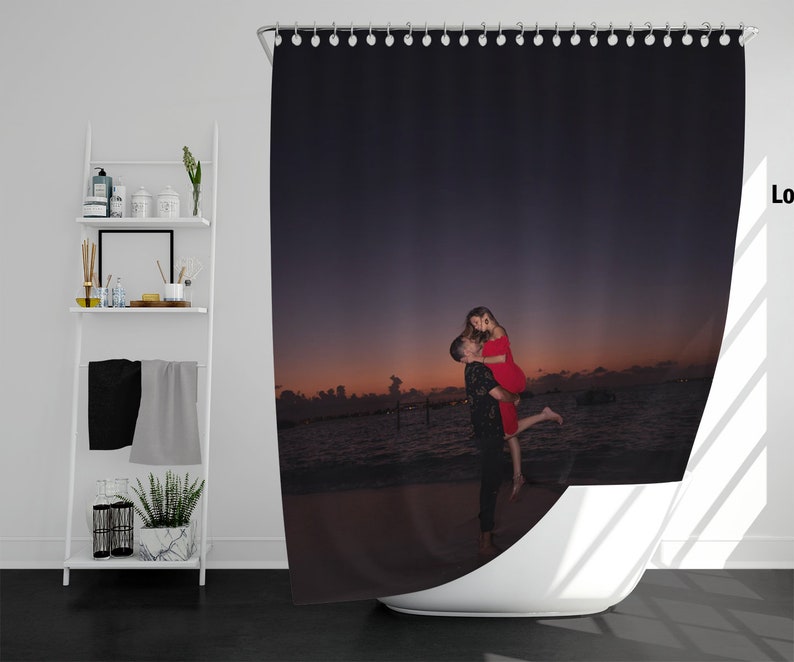 May include: A couple in love, embracing on a beach at sunset. The woman is wearing a red dress and the man is wearing a black shirt. The couple is silhouetted against the orange and purple sky.