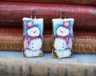 Handmade ceramic white snowman illustration charms with 24kt gold lustre edge