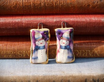 Handmade ceramic white snowman illustration charms with 24kt gold lustre edge