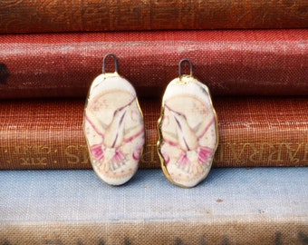 Handmade ceramic hummingbird illustration charms with a 24kt gold lustre edge