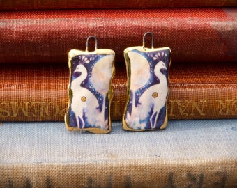 Handmade ceramic white peacock illustration charms with a 24kt gold lustre edge