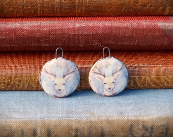 Handmade ceramic charms with an illustration of a deer / stag