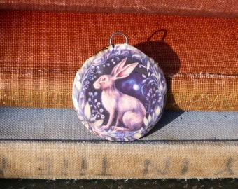 Handmade ceramic pendant with an illustration of a hare/rabbit