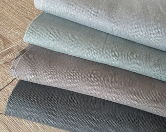 May include: Four fabric swatches in different shades of gray, from light to dark. The swatches are folded on top of each other, with the lightest shade on top and the darkest shade on the bottom.