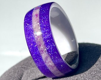 May include: A purple and white glitter ring with a white band and a purple glitter band with white glitter accents.