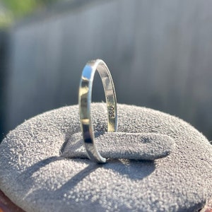 Op de afbeelding: Close-up van een zilveren ring met het nummer "935" gestempeld op de binnenkant van de band.