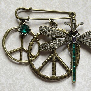 Dragonfly Jewelry - One Loop Kilt Safety Pin; Charms: Wonky Peace Sign, Green Rhinestone, Large Hammered Peace Symbol, Dragonfly Pendant