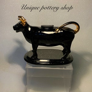 An awesome 19th c Staffordshire, black bull figurine creamer