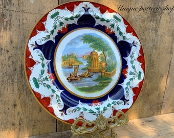 Una impresionante crema Wedgwood antigua del siglo 19 pintada a mano, placa azul flujo