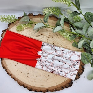 May include: Red and white headband with a baseball stitch pattern. The headband is made of a soft, stretchy fabric and is perfect for keeping your hair out of your face.