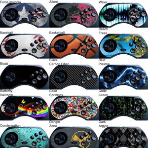May include: Collection of game controllers with various designs. Includes controllers with themes like Air Force Insignia, Baseball, Basketball, Beach Trees, Carbon Fiber, Blue Plasma, Rainbow Butterfly, Cake Sprinkles, Code Green, and Dark Argyle.