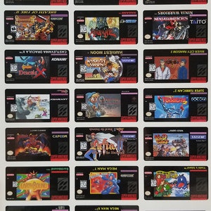 May include: A collection of 18 Super Nintendo game cartridge labels. The labels are black with white text and graphics. The games include Final Fantasy III, Final Fight Guy, Harvest Moon, Castlevania Dracula X, Mega Man 7, Mega Man X, Mega Man X3, Earthbound, Yoshi's Island, and more.