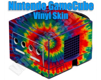 May include: A Nintendo GameCube console with a vibrant tie-dye vinyl skin. The skin features a swirling pattern of red, yellow, blue, and purple. The text "Nintendo GameCube Vinyl Skin" is displayed in blue. The console has a white front panel with circular vents.