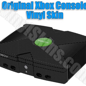 May include: Black Xbox console with a carbon fiber vinyl skin. The console has a green "Xbox" logo on the top.
