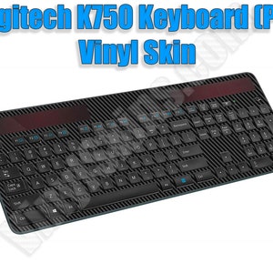 May include: A black Logitech K750 keyboard with a carbon fiber vinyl skin. The keyboard has a numeric keypad and a row of function keys.