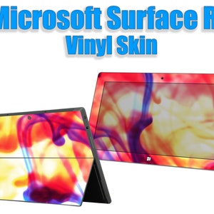 May include: Microsoft Surface RT vinyl skin with a vibrant abstract design in red, yellow, and purple. The image shows the skin applied to a tablet, with the text "Microsoft Surface RT Vinyl Skin" at the top.