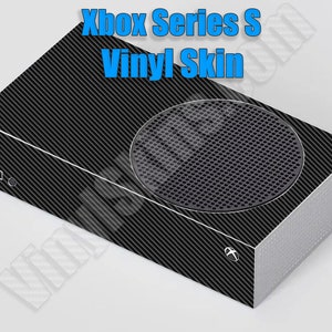 May include: Black Xbox Series S console with a carbon fiber vinyl skin. The skin covers the entire console, including the front, sides, and back. The Xbox logo is visible on the front of the console.