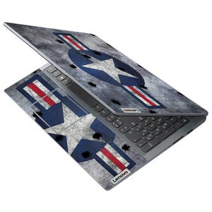 May include: A Lenovo laptop with a custom skin featuring a distressed gray background and a large blue star with white accents and red stripes. The laptop is open, displaying the keyboard and screen.