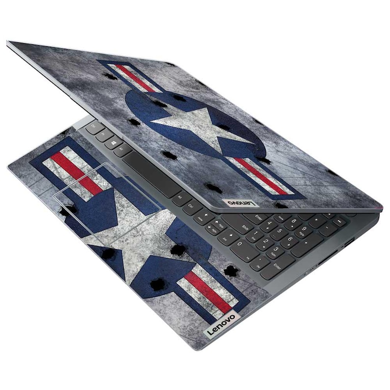 May include: A Lenovo laptop with a custom skin featuring a distressed gray background and a large blue star with white accents and red stripes. The laptop is open, displaying the keyboard and screen.