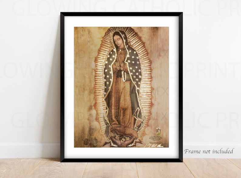 May include: A vintage-style print of Our Lady of Guadalupe, a religious icon, depicted in a gold-toned frame. The image shows a woman in a blue robe with a gold crown, standing on a crescent moon.