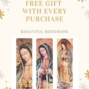 May include: Three bookmarks featuring a religious image of the Virgin Mary. The bookmarks are gold and have a religious inscription in Spanish. The bookmarks are on a white background with gold and grey stars.