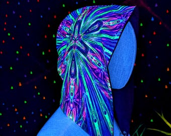 May include: A vibrant, patterned hood with a striking neon design in shades of blue, green, and pink. The hood is displayed on a blue mannequin head, with a dark background adorned with colorful dots. The hood features a unique, eye-catching pattern.