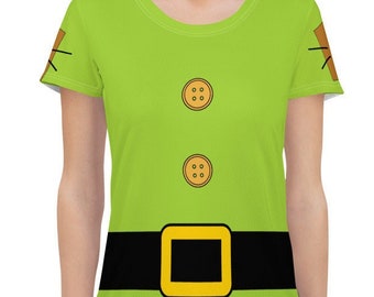May include: A green short-sleeved t-shirt with a black belt and two brown buttons. The shirt has a cartoon-style design of a character's torso.