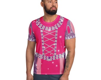 May include: A short-sleeved pink t-shirt featuring a design resembling a princess dress. The design includes a decorative neckline, a criss-cross bodice, and sparkling embellishments. The sleeves have a purple and white pattern.