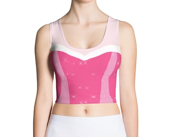 Könnte beinhalten: Rosa-weißes Crop-Top mit Prinzessinnen-Design. Das Oberteil hat ein rosa Mieder mit weißem Ausschnitt und einen rosa Rock mit weißem Bund.