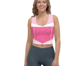 Könnte beinhalten: Ein rosa-weißes Crop-Top mit floralem Muster. Das Top hat einen runden Ausschnitt und ist ärmellos.