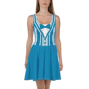 May include: A blue dress with a white and blue striped pattern that resembles a tuxedo. The dress has a scoop neck and a fitted bodice. The skirt is a-line and falls to the knees.