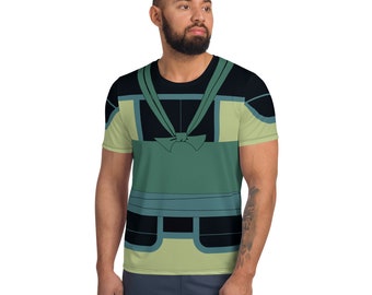 May include: A green, black, and blue short-sleeved t-shirt with a graphic print of a stylized character wearing a vest.