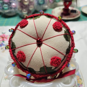 Machine Embroidered pin cushion with hand crocheted bottom and han embroidered bullion roses