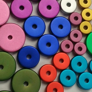 May include: Assortment of colorful round metal beads with a hole in the center. The beads are various shades of green, blue, red, pink, gold, and silver.