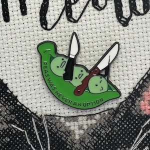 May include: A green pea pod with three peas inside. The peas have faces and are being stabbed by two knives. The text on the pod reads "Peas Was Never An Option".