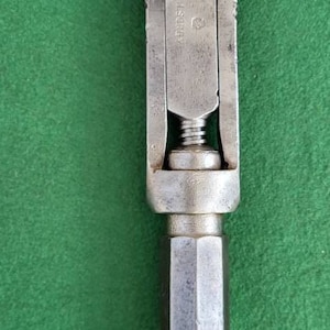 May include: A silver adjustable wrench with a hexagonal handle and the text "L.S. Starrett" on the side.