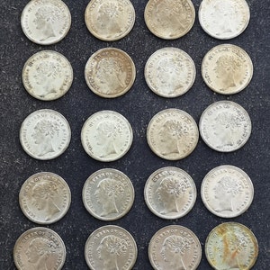 Puede incluir: Una colección de 24 monedas de plata con el perfil de la reina Victoria. Las monedas están dispuestas en cuatro filas de seis monedas cada una. Las monedas están todas en buen estado y tienen una pátina ligeramente desgastada.