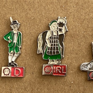 Vintage Shell Gas/Öl Pin Buttons. Vier Shell-Gas-Werbung Pin-Abzeichen, die europäische Länder traditionelle Kleidung zeigen.