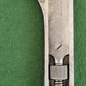 May include: A vintage adjustable wrench, made of steel, with a textured, aged appearance. The wrench features a screw mechanism for adjusting the jaw size. The text "GIRDER MAJOR No93 JOSEPH LUCAS LTD BIRMINGHAM" is visible.