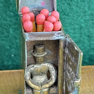 Antique Brass Novelty Vesta Case. Antique Novelty Brass Vesta Case In The Shape Of An Outhouse With Seated Gentleman.