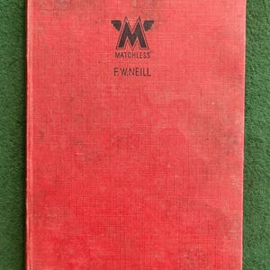 Puede incluir: Un libro rojo con un logotipo negro de Matchless y el texto "F.W. NEILL" en la portada.