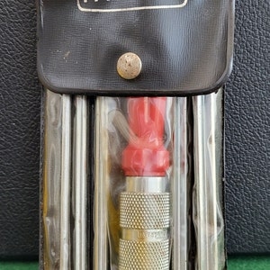 May include: A set of screwdrivers in a black leather case with the word "PARAMO" printed on the front. The screwdrivers are in a clear plastic sleeve and have red handles. The screwdrivers are labeled "GUARANTEE".