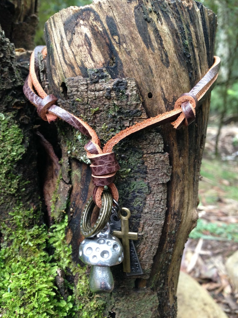 Mushroom necklace with an adjustable brown leather neck strap with rings and crucifix