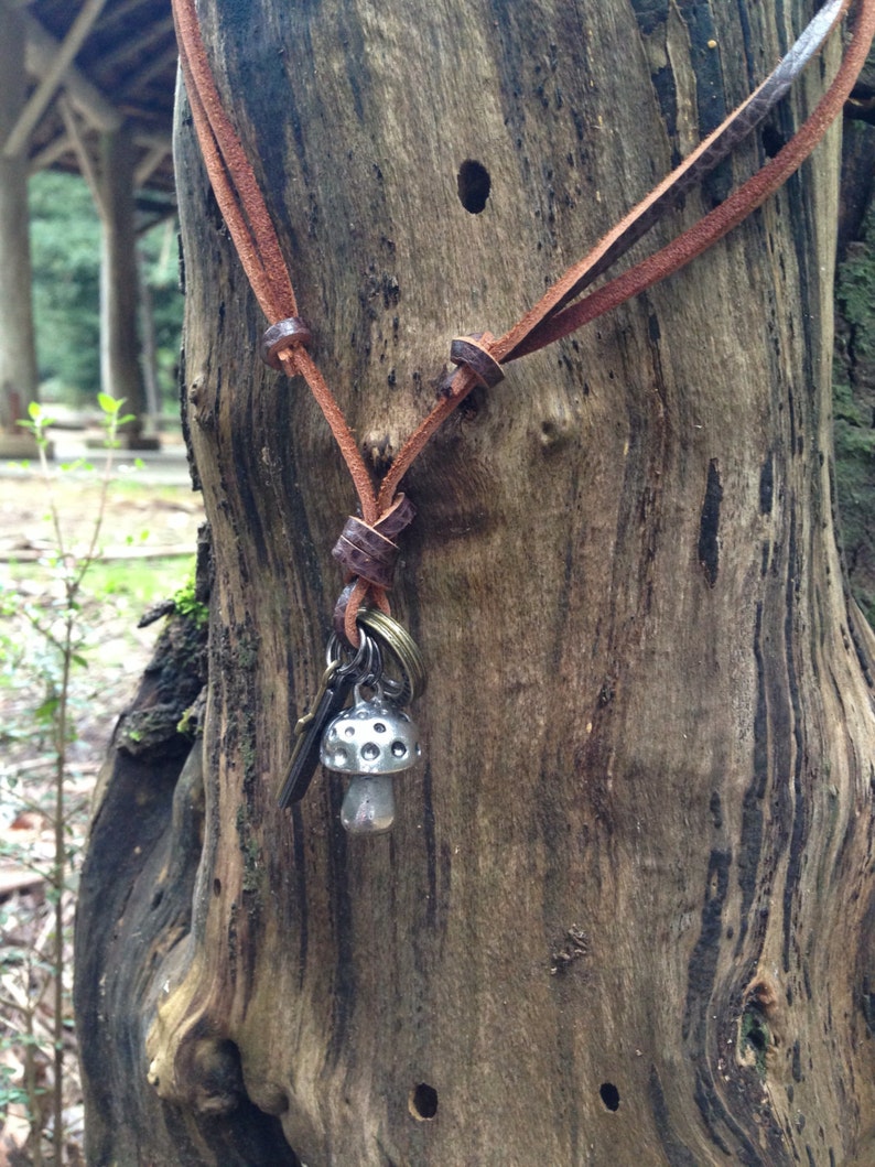 Mushroom necklace with an adjustable brown leather neck strap with rings and crucifix
