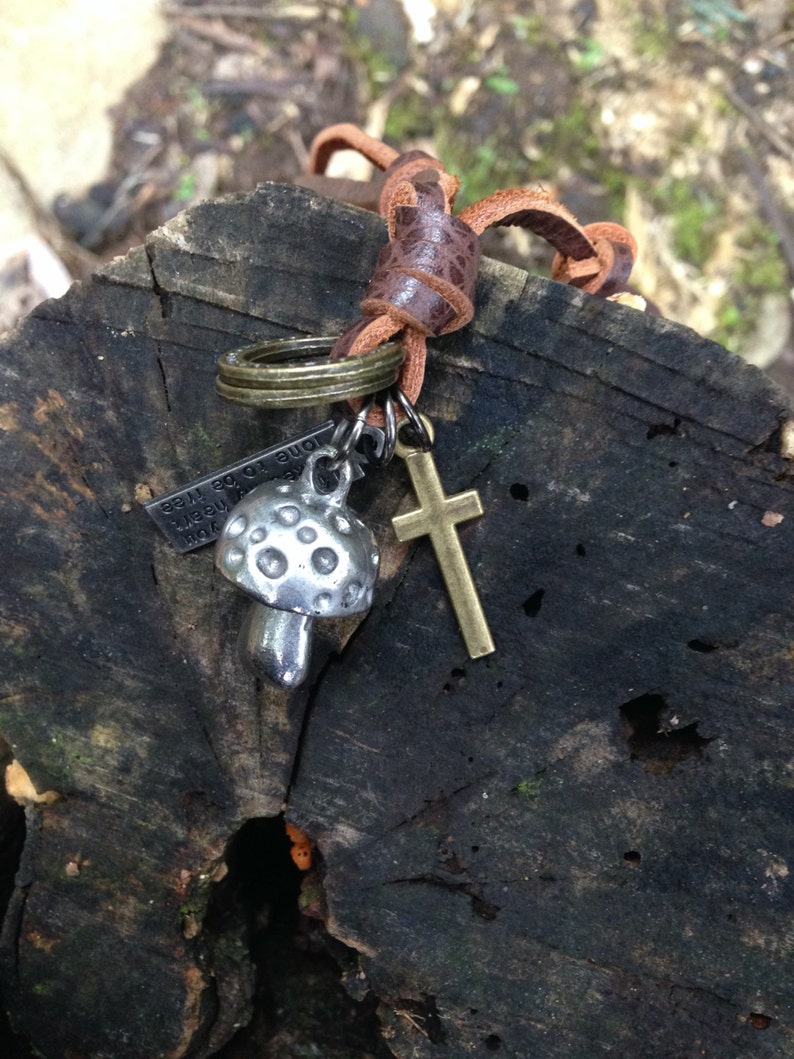 Mushroom necklace with an adjustable brown leather neck strap with rings and crucifix