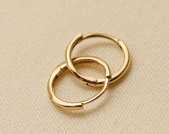 May include: A pair of gold hoop earrings. The earrings are simple and elegant, and they would make a great gift for any occasion.