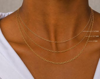May include: Three gold-toned chain necklaces with elongated oval links, layered together. The chains are labeled with widths of 1.8 mm, 2.7 mm, and 3 mm, indicating the varying thickness of the individual links in each necklace.